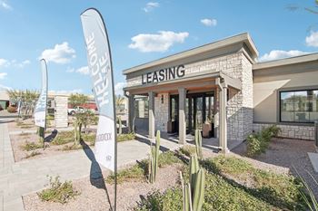A leasing office with cactus signs in front of it